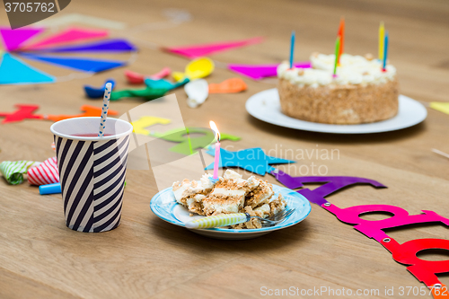 Image of Lit Candles On Birthday Cake At Table