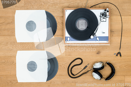 Image of Vintage Turntable And Records On Wooden Table