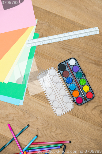 Image of Watercolor Paints With Craft Papers On Table