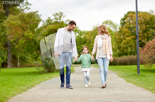 Image of happy family walking in summer park