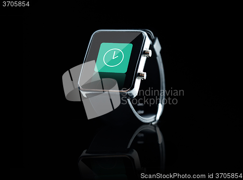 Image of close up of black smart watch with clock icon