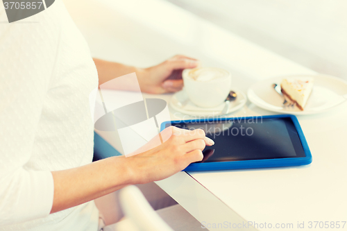 Image of close up of woman with tablet pc drinking coffee