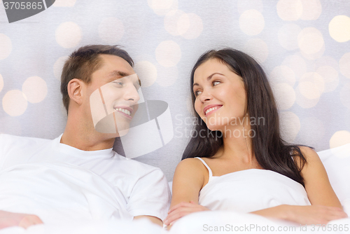 Image of happy couple dreaming in bed