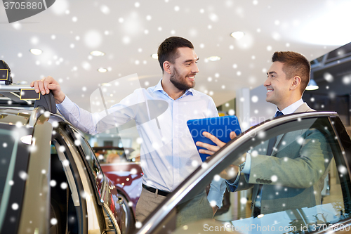 Image of happy man with car dealer in auto show or salon