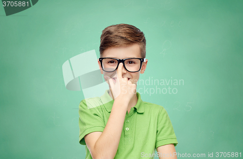 Image of happy school boy in green t-shirt and eyeglasses