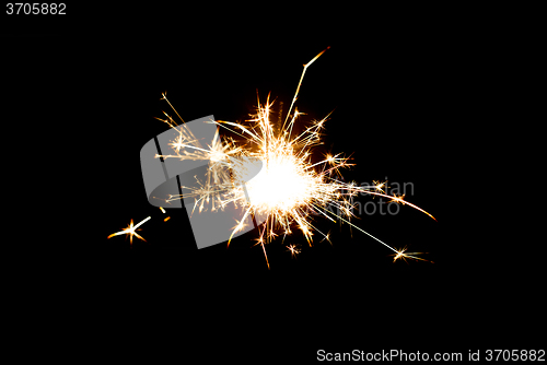 Image of sparkler or bengal light burning over black