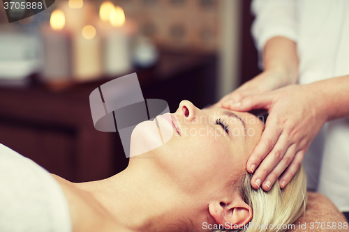 Image of close up of woman having face massage in spa