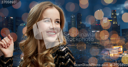 Image of happy young woman dancing at night club disco