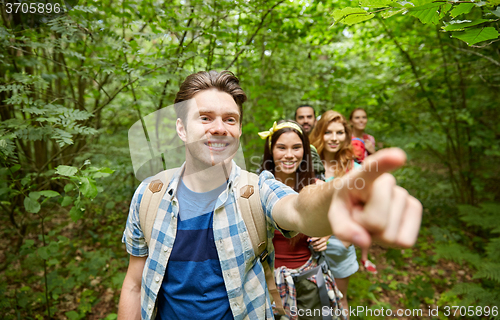 Image of group of smiling friends with backpacks hiking