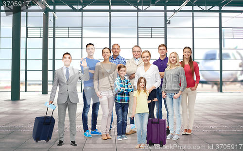 Image of group of smiling people over airport terminal