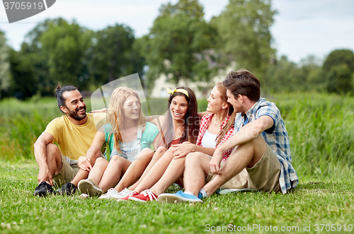 Image of group of smiling friends talking outdoors
