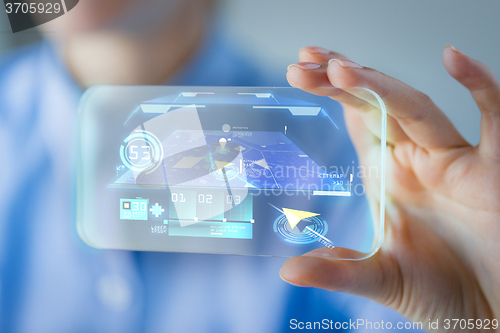 Image of close up of woman with transparent smartphone