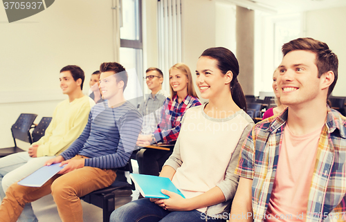 Image of group of smiling students in lecture hall