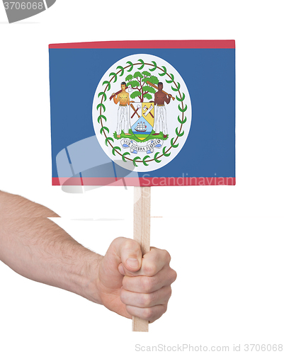 Image of Hand holding small card - Flag of Belize