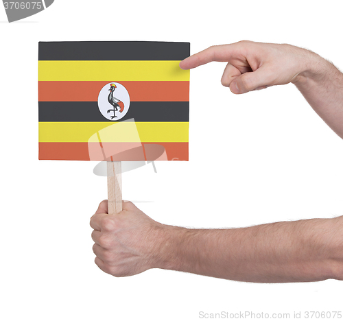 Image of Hand holding small card - Flag of Uganda