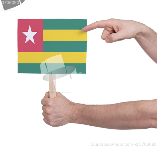 Image of Hand holding small card - Flag of Togo