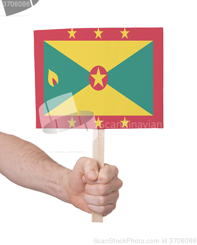 Image of Hand holding small card - Flag of Grenada