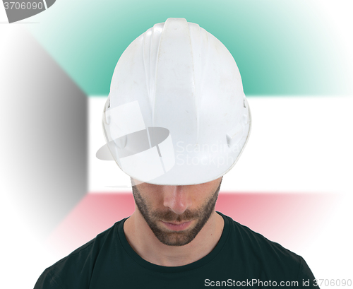 Image of Engineer with flag on background - Kuwait