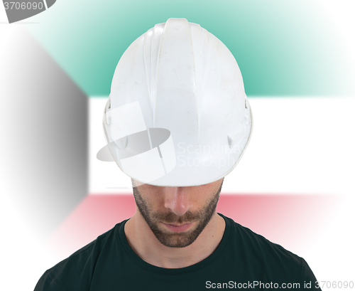 Image of Engineer with flag on background - Kuwait