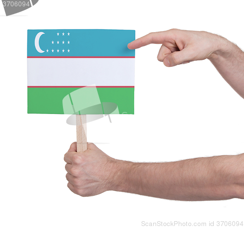 Image of Hand holding small card - Flag of Uzbekistan