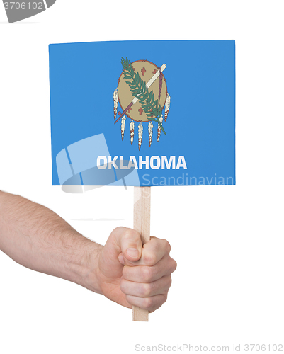 Image of Hand holding small card - Flag of Oklahoma