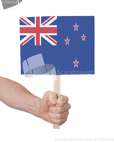 Image of Hand holding small card - Flag of New Zealand
