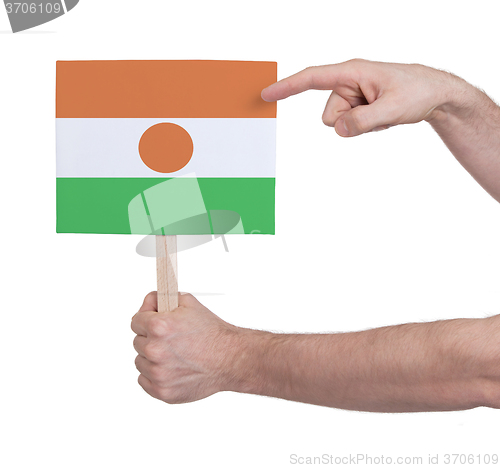 Image of Hand holding small card - Flag of Niger