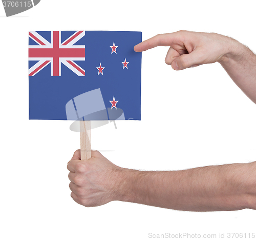 Image of Hand holding small card - Flag of New Zealand