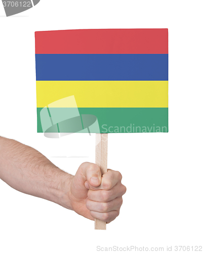 Image of Hand holding small card - Flag of Mauritius