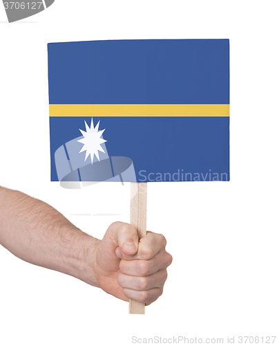 Image of Hand holding small card - Flag of Nauru