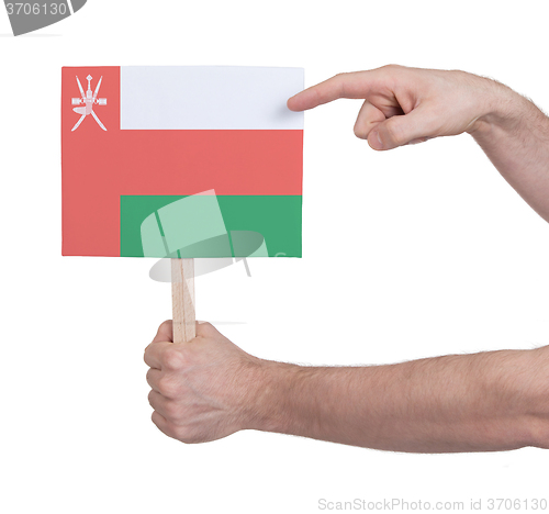Image of Hand holding small card - Flag of Oman