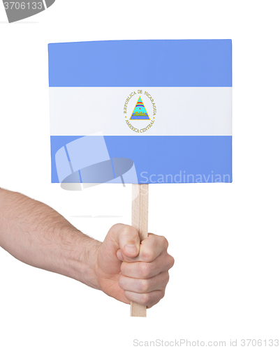 Image of Hand holding small card - Flag of Nicaragua