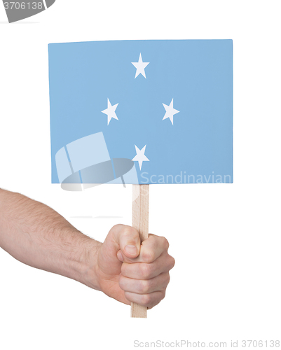 Image of Hand holding small card - Flag of Micronesia