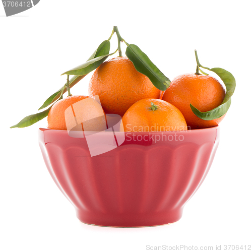 Image of Tangerines on ceramic red bowl 