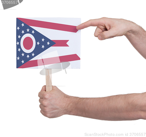 Image of Hand holding small card - Flag of Ohio