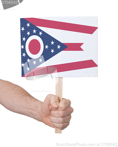 Image of Hand holding small card - Flag of Ohio