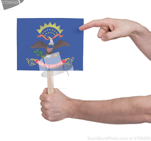 Image of Hand holding small card - Flag of North Dakota