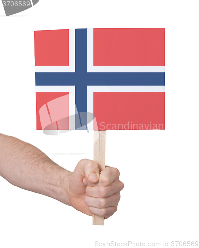 Image of Hand holding small card - Flag of Norway