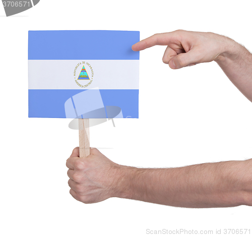 Image of Hand holding small card - Flag of Nicaragua
