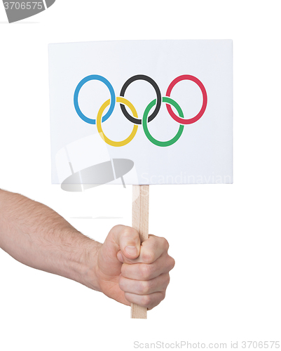 Image of Hand holding small card - Flag of the Olympic games