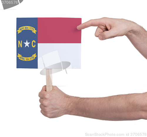 Image of Hand holding small card - Flag of North Carolina