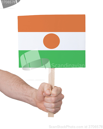 Image of Hand holding small card - Flag of Niger