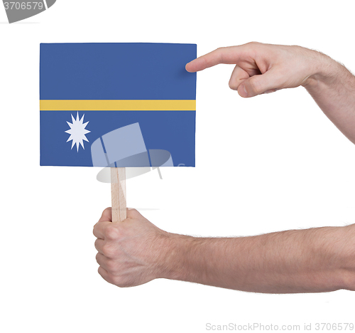 Image of Hand holding small card - Flag of Nauru
