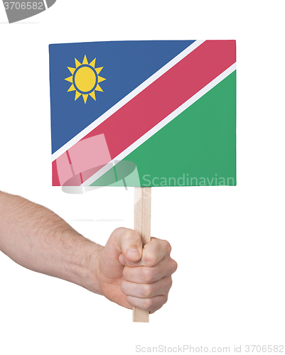 Image of Hand holding small card - Flag of Namibia