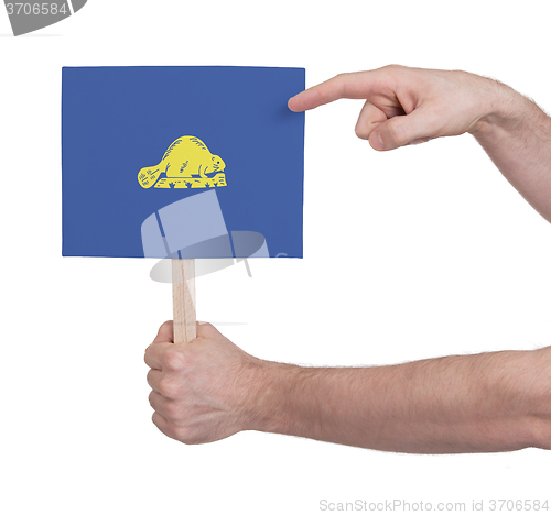 Image of Hand holding small card - Flag of Oregon