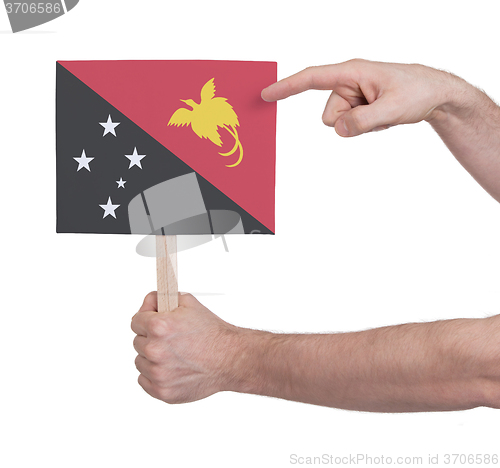 Image of Hand holding small card - Flag of Papua New Guinea