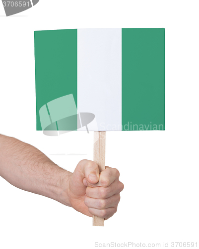 Image of Hand holding small card - Flag of Nigeria