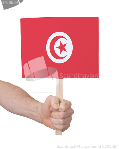 Image of Hand holding small card - Flag of Tunisia