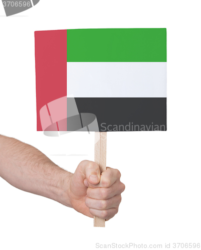 Image of Hand holding small card - Flag of Sudan