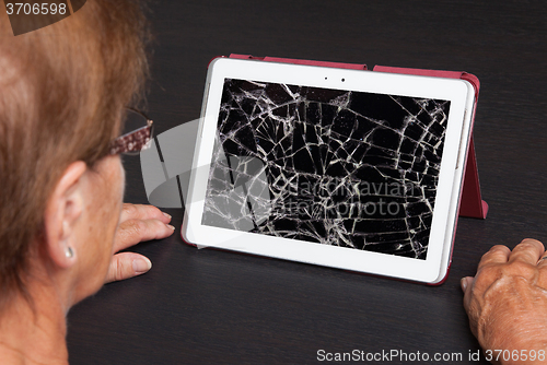 Image of Senior lady with tablet, cracked screen